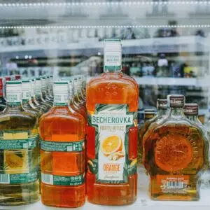 An array of vibrant liquor bottles displayed in a store showcase highlighting various spirits.